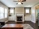 Comfortable living room showcasing a fireplace with built-in shelving, hardwood floors, and natural light at 33 Northlodge Ct, Wendell, NC 27591