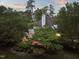 Charming backyard with a stone patio and lush landscaping creating a private and inviting outdoor space at 3307 Devon Rd, Durham, NC 27707