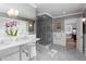 Elegant bathroom with double sinks, marble floors, a glass shower, and stylish lighting at 3307 Devon Rd, Durham, NC 27707