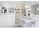 Bathroom featuring double sinks, ample built-in storage, and mirrored wall cabinets at 3307 Devon Rd, Durham, NC 27707