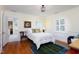 Bedroom with wood floors, white walls, and view to the attached bathroom at 3307 Devon Rd, Durham, NC 27707