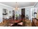 Elegant dining room featuring paneled walls, chandelier lighting and hardwood floors at 3307 Devon Rd, Durham, NC 27707
