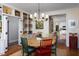 Colorful dining area with built-in shelving and chandelier lighting at 3307 Devon Rd, Durham, NC 27707