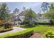 Elegant home with a circular driveway, lush landscaping, and classic architectural details exudes curb appeal at 3307 Devon Rd, Durham, NC 27707