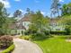Beautiful two-story white brick home with a circular driveway and manicured front lawn at 3307 Devon Rd, Durham, NC 27707