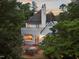 An exterior view of the back of the home highlighting a patio and upper balcony at 3307 Devon Rd, Durham, NC 27707