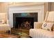 Elegant fireplace with a marble surround, complemented by cozy seating and a decorative fireplace screen at 3307 Devon Rd, Durham, NC 27707