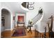Welcoming foyer showcases a curved staircase, wood floors, and elegant decor at 3307 Devon Rd, Durham, NC 27707