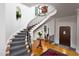 Welcoming foyer with a staircase, rich wood floors, and a decorative railing at 3307 Devon Rd, Durham, NC 27707