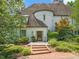 Charming front entrance with brick steps leading to a wood door, complemented by manicured landscaping at 3307 Devon Rd, Durham, NC 27707