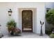 Inviting front entrance featuring a beautifully decorated door, stylish lantern, and elegant potted plants at 3307 Devon Rd, Durham, NC 27707