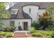 Charming white brick home with a turret, complemented by a lush green landscaped front yard and brick walkway at 3307 Devon Rd, Durham, NC 27707