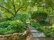 Picturesque garden with stone steps, lush plants, and vibrant hydrangeas creating a tranquil outdoor space at 3307 Devon Rd, Durham, NC 27707