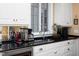 Kitchen countertop with beverage station, sink, white cabinets and window at 3307 Devon Rd, Durham, NC 27707