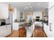 Spacious kitchen showcasing white cabinets, stainless steel appliances and hardwood floors at 3307 Devon Rd, Durham, NC 27707