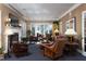 Cozy living room with a fireplace, natural light, hardwood accents, and neutral decor at 3307 Devon Rd, Durham, NC 27707