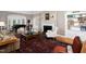Spacious living room with fireplace, grand piano and comfortable seating, featuring traditional furnishings at 3307 Devon Rd, Durham, NC 27707