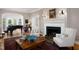 Cozy living room with a fireplace, comfortable seating, and a grand piano in the adjacent area at 3307 Devon Rd, Durham, NC 27707