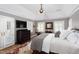 Beautiful main bedroom with a tray ceiling, multiple windows, and a flat-screen TV at 3307 Devon Rd, Durham, NC 27707