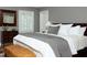 A well-lit main bedroom features an upholstered bench and a window with white shutters at 3307 Devon Rd, Durham, NC 27707