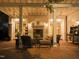 Cozy outdoor patio with brick fireplace, ceiling fans, and comfortable seating area at 3307 Devon Rd, Durham, NC 27707