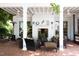 Relaxing covered outdoor patio with fireplace, brick floor, ceiling fans, and comfortable seating at 3307 Devon Rd, Durham, NC 27707