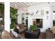Cozy covered patio with fireplace, comfortable seating, and a ceiling fan at 3307 Devon Rd, Durham, NC 27707