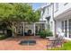Relaxing backyard brick patio with fireplace, outdoor seating, and fountain at 3307 Devon Rd, Durham, NC 27707