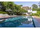 Relaxing pool area with lounge chairs and a large sun umbrella at 3307 Devon Rd, Durham, NC 27707