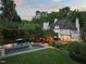 Aerial view of an outdoor pool with lounge chairs and lush landscaping surrounding the home at 3307 Devon Rd, Durham, NC 27707