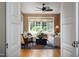 Bright and airy sunroom with casual seating and a decorative ceiling fan, filled with natural light at 3307 Devon Rd, Durham, NC 27707