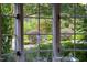 Close up of a window with decorative glass; view of the professionally landscaped yard and garden at 3307 Devon Rd, Durham, NC 27707