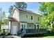 Exterior view of the two-story home with a deck, showcasing its architectural details at 3317 E Jameson Rd, Raleigh, NC 27604