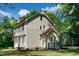 Side view of a home with light siding, a brown roof, and a well-kept green lawn at 3317 E Jameson Rd, Raleigh, NC 27604