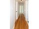 Inviting hallway featuring gleaming hardwood floors and neutral paint at 3317 E Jameson Rd, Raleigh, NC 27604