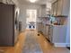 Kitchen features stainless appliances and access to a dining area beyond at 3317 E Jameson Rd, Raleigh, NC 27604