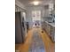 Open kitchen features stainless appliances and access to a dining area beyond at 3317 E Jameson Rd, Raleigh, NC 27604