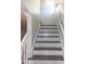 Traditional staircase with white banister, carpeted treads, and natural light, providing an inviting entrance at 3317 E Jameson Rd, Raleigh, NC 27604