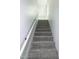Carpeted stairway with white railing at 3317 E Jameson Rd, Raleigh, NC 27604