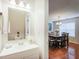 Stylish half bathroom featuring a modern vanity, white fixtures, and easy access to the dining area at 3515 Mountain Brook Cir, Durham, NC 27704
