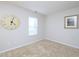 Comfortable bedroom featuring carpet, natural light, and classic clock decor at 3515 Mountain Brook Cir, Durham, NC 27704