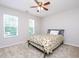 Cozy bedroom featuring a bed, ceiling fan, and windows providing natural light at 3515 Mountain Brook Cir, Durham, NC 27704