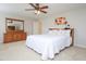 Bright bedroom with a ceiling fan, bed, and a dresser with mirror at 3515 Mountain Brook Cir, Durham, NC 27704