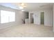 A spacious bonus room with neutral carpet, ceiling fan, stairs, and 3 closets at 3515 Mountain Brook Cir, Durham, NC 27704
