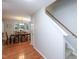 Open-concept dining area with hardwood floors and a chandelier, adjacent to the stairway at 3515 Mountain Brook Cir, Durham, NC 27704