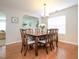 Elegant dining room featuring wood floors, a chandelier, and a view into the adjacent room at 3515 Mountain Brook Cir, Durham, NC 27704