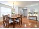 Inviting dining area with hardwood floors, chandelier, and adjacent entry area at 3515 Mountain Brook Cir, Durham, NC 27704