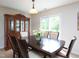 Inviting dining room features a wooden table, china cabinet, and a sliding glass door to let light in at 3515 Mountain Brook Cir, Durham, NC 27704