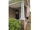 Charming front porch with stone pillar, and a decorative wreath on the front door at 3515 Mountain Brook Cir, Durham, NC 27704