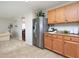 Spacious kitchen features stainless steel refrigerator, wooden cabinets, and tiled floor for easy maintenance at 3515 Mountain Brook Cir, Durham, NC 27704